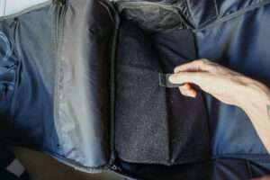 hand folding inner compartment of backpack up