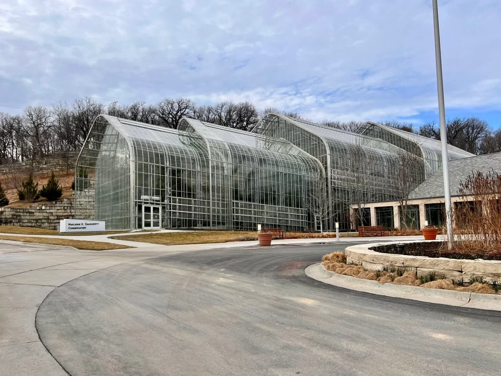 photo from the street overlooking a glass greenhouse