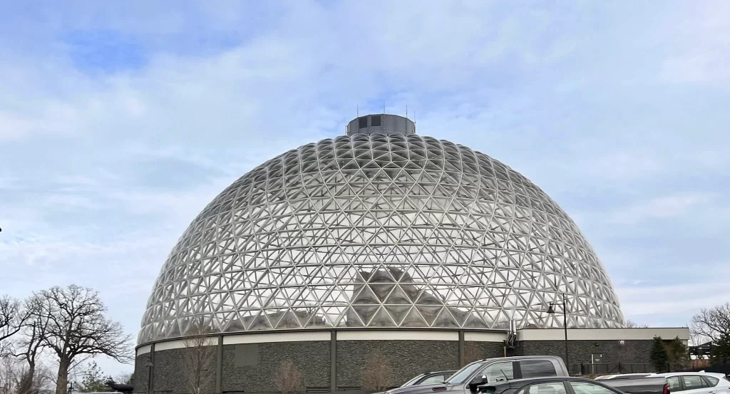 large glass dome against a cloudy sky