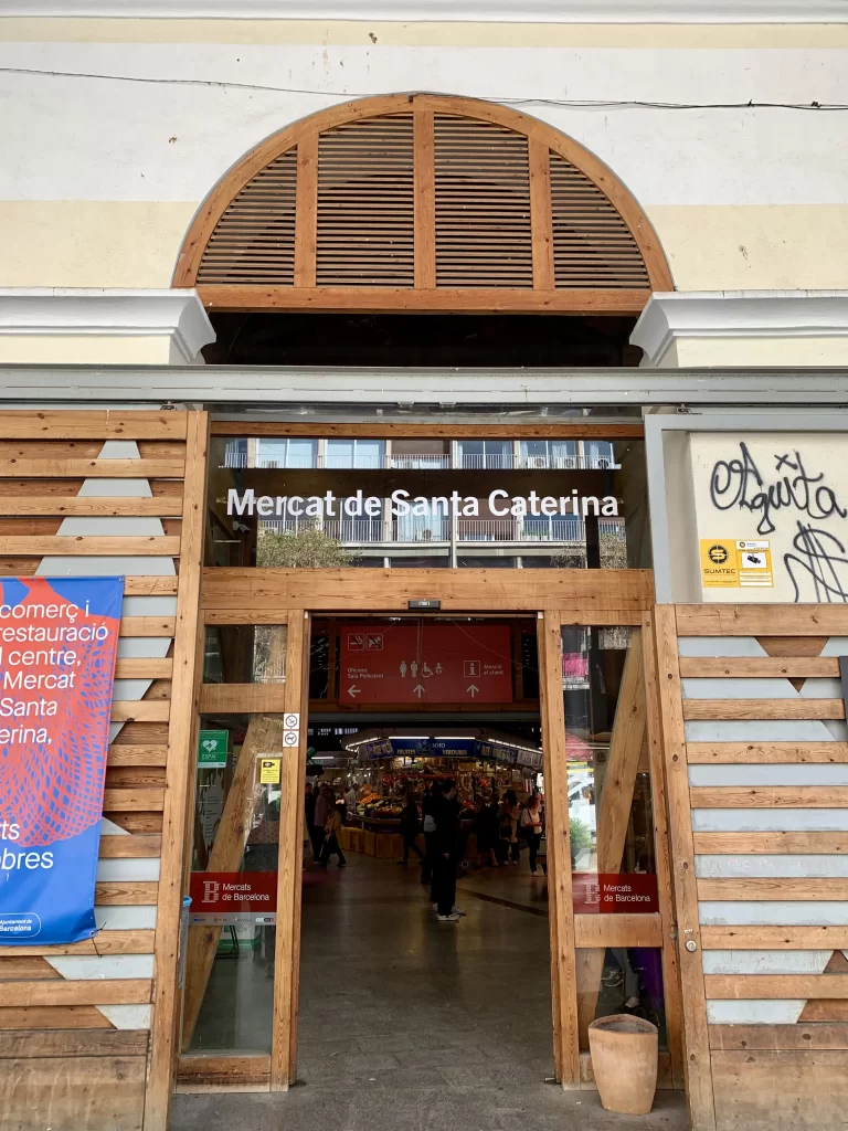 Brown paneled entrance to a food market with vendor stalls inside