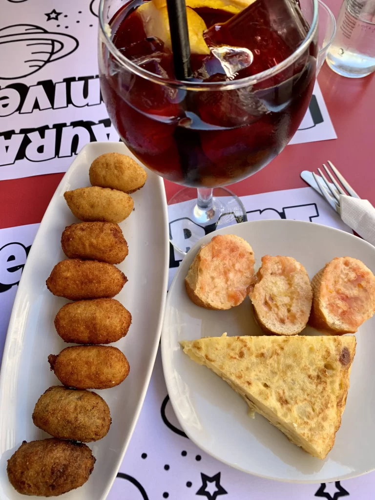 image of spanish tapas from above with a glass of sangria