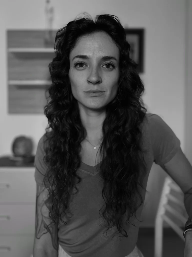 Black and white photo of a woman looking directly at the camera