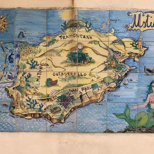 A yellow mural map of an island on a blue background