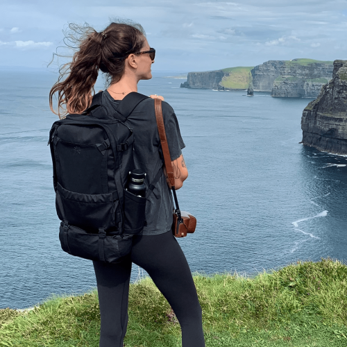 back view of backpack against the Cliffs of Moher