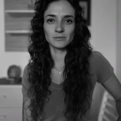 Black and white photo of a woman looking directly at the camera